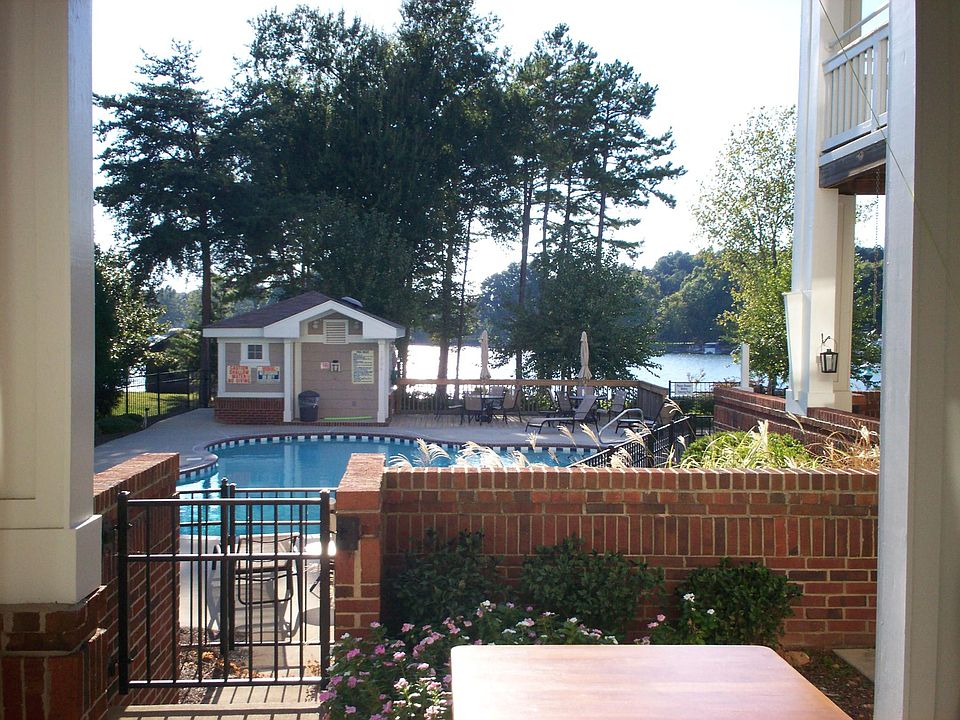 View from covered patio out to pool and lake.