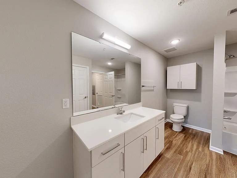 The bathroom in The Sycamore can be access directly from the bedroom or living space, and features a large vanity and shower/bathtub. The bathroom in The Sycamore can be access directly from the bedroom or living space, and features a large vanity and sho