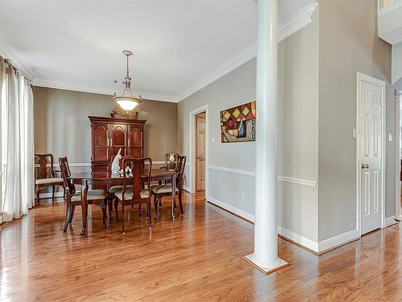 Wood flooring downstairs adds to the open design of the living and dining areas.