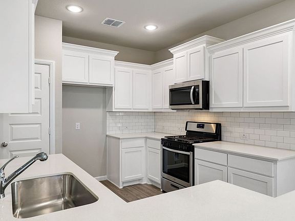 Kitchen in the Sapphire home plan by Trophy Signature Homes - REPRESENTATIVE PHOTO