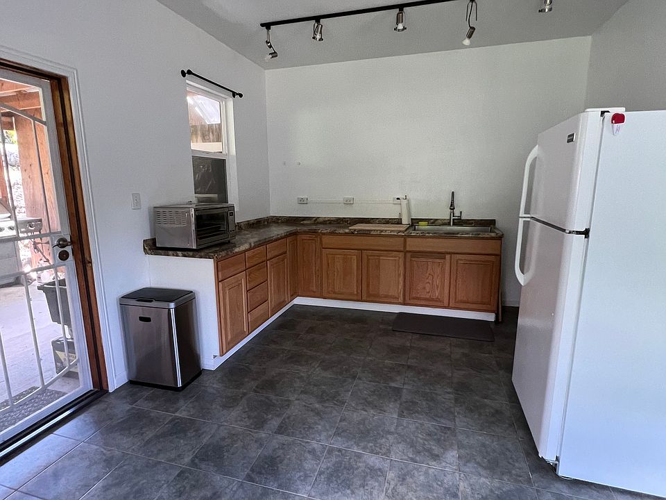 Kitchenette with back door entrance/exit to shared covered lanai-storage-bbq area