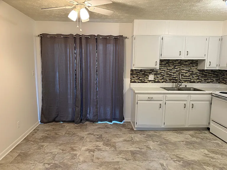 Large updated eat-in Kitchen with large sliding door to outside for even more light.