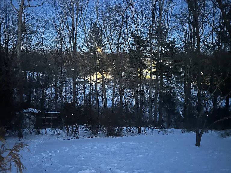 moonrise over snow backyard