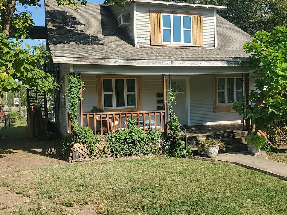 Balcony entrance is on the left side of house.