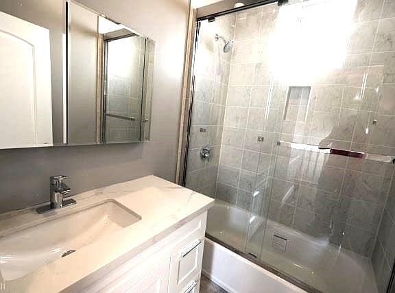 Modern bathroom with German fixtures, auto temp sensing shower, quartz counters, ventilation fan.