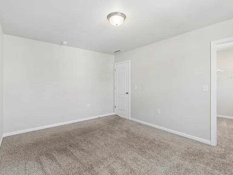 Bedroom with walk in closet and plenty of room for a dresser