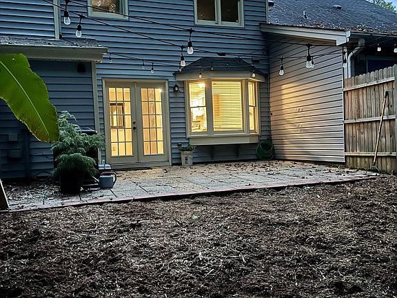 Private backyard with patio and yard.