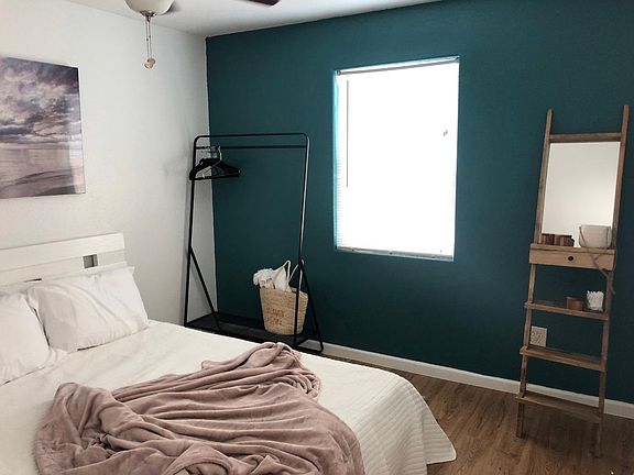 bedroom with queen sized bed and closet rack!