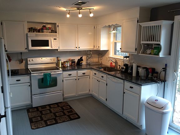 Kitchen includes pantry closet, range, microwave, dishwasher, and refrigerator