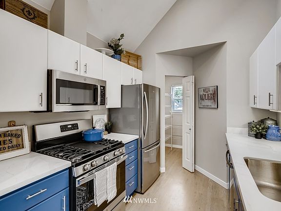 New quartz counters and stainless steel appliances (including gas range) finish off this efficient kitchen floorplan. 