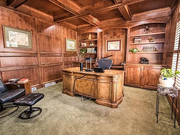 Handsome fully paneled den with coffered ceiling and 2 sets of built-ins.