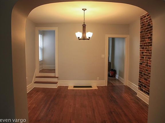 Large central dining room with more exposed brick
