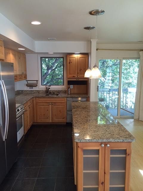 your kitchen with serene back deck nearby