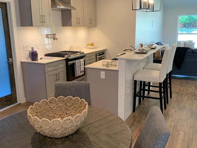 OPEN KITCHEN WITH ISLAND/BAR AREA BETWEEN LIVING AND DINING AREAS