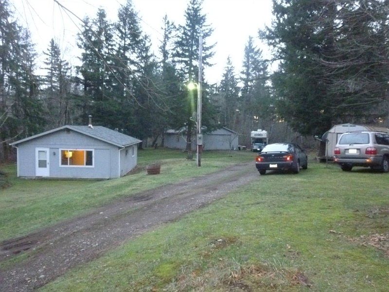 Welcome to country living. Beautiful setting on 3.18 Acres of green grass, woods and even a bit of lakefront