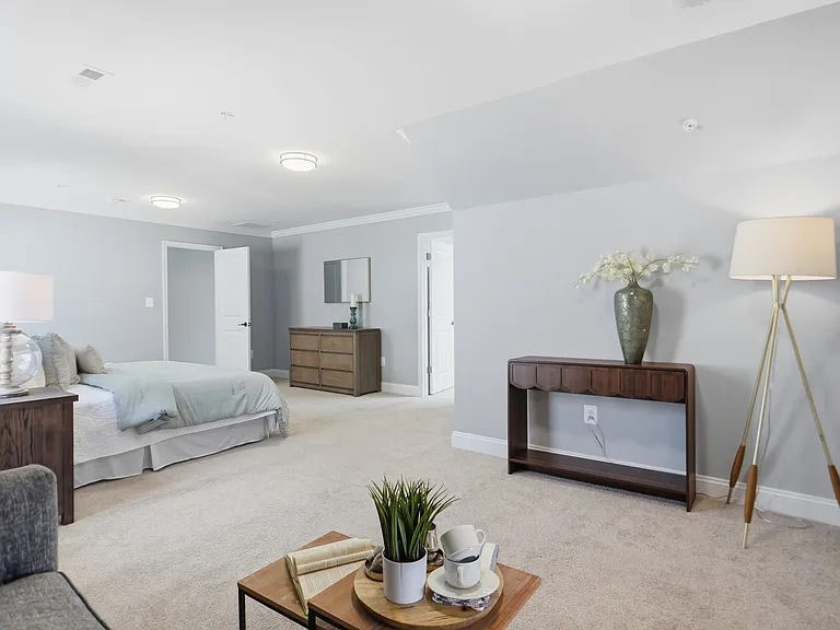 Master bedroom with sitting area, massive walk-in closet, and custom spa-like en-suite with soaking tub.