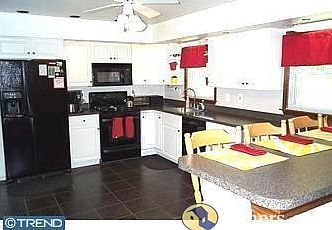large updated kitchen with slate tile floor