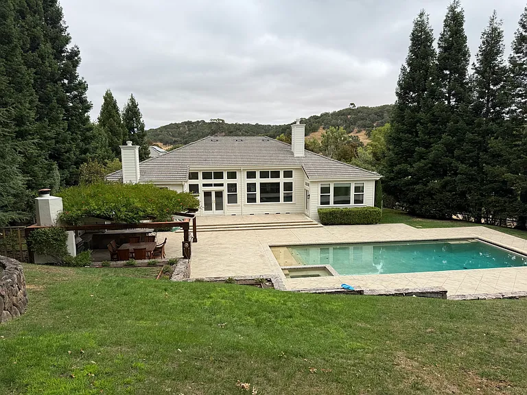 View of backyard from upper hillside seating area
