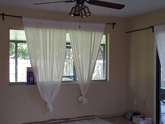 Living room with L- shaped screen room beyond