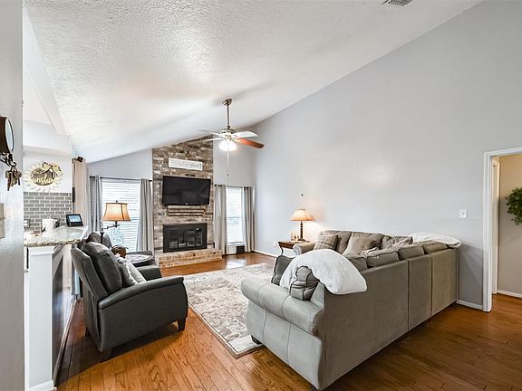 Family room featuring wood floors, fireplace and vaulted ceilings.