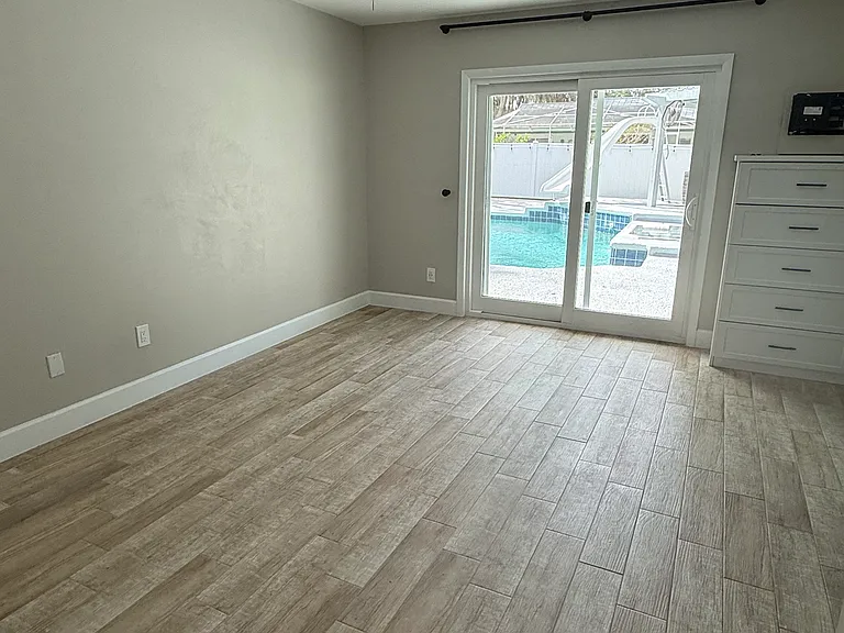 master bedroom with a slider to outside pool area