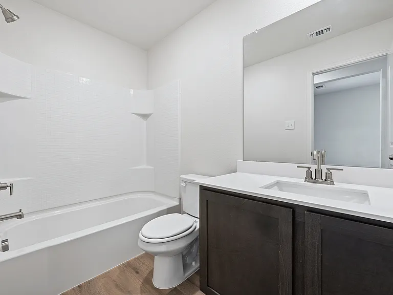 The secondary bathroom of the Sabine has a large vanity and shower-tub combo.