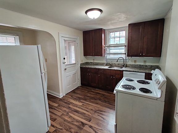 Kitchen with electric stove, dishwasher, garbage disposal, and refrigerator
