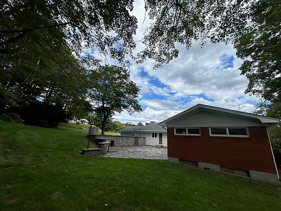 Exterior side view, plenty of green space and beautiful outdoor patio