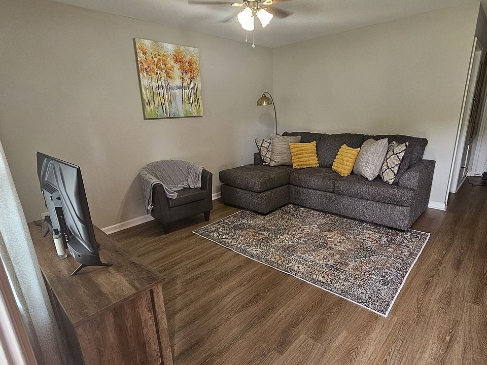 Upgraded living room with fresh new paint, laminate flooring and ceiling fan.