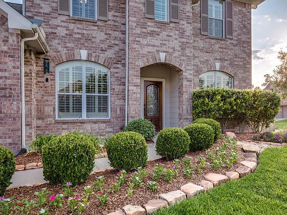 Notice the lush landscaping that leads you and your guest to the beautiful leaded glass door