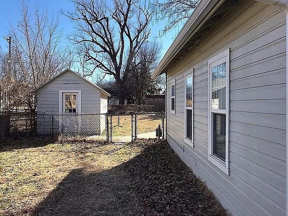 fenced in backyard with shed