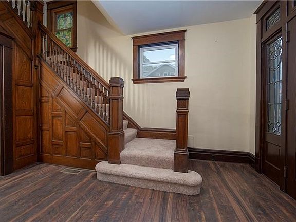 Another view from the entry into the formal living room.  The grand balustrade gives a view of more beautiful wood and a peek at