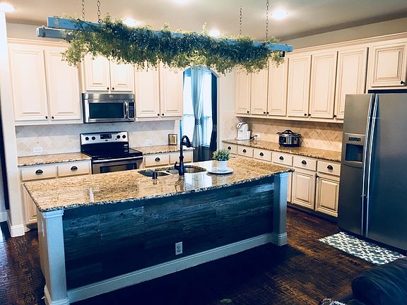 Extended island provides space for barstool seating if desir