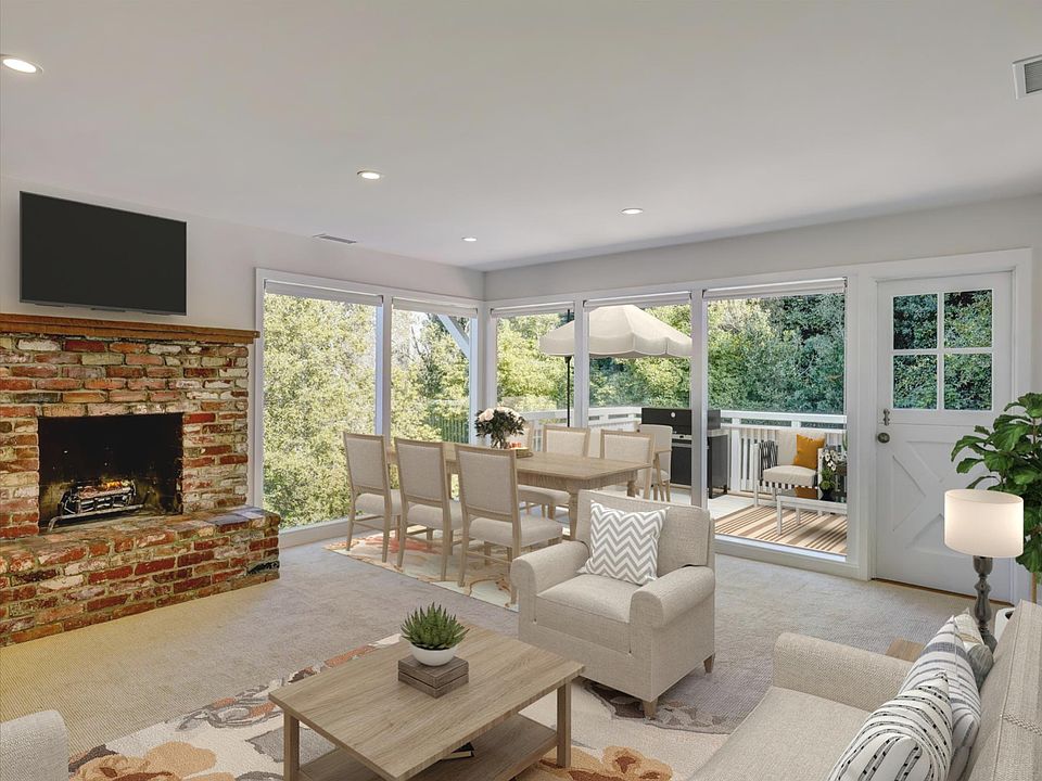Living room with fireplace opening to deck