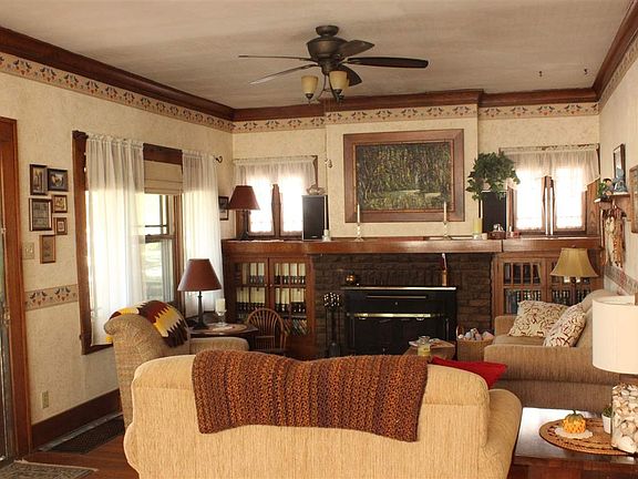 Step inside and notice the hardwood floors, woodwork, bookshelves and fireplace...