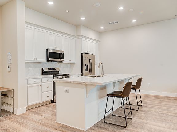 Kitchen showing island and cabinets and appliances