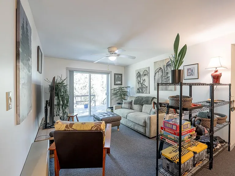 secondary living room with sliding doors that lead out to private deck