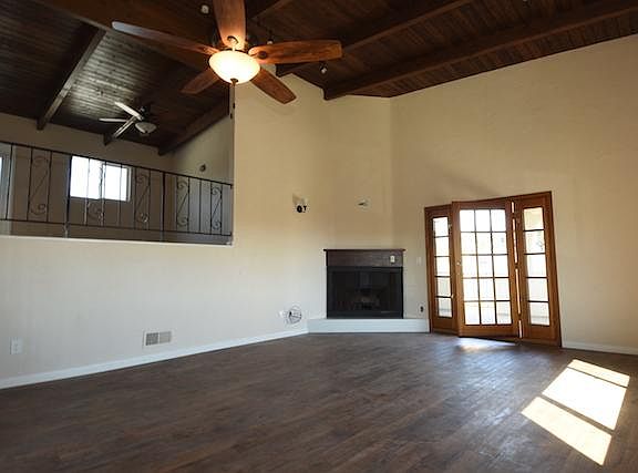 Living room with fireplace and balcony