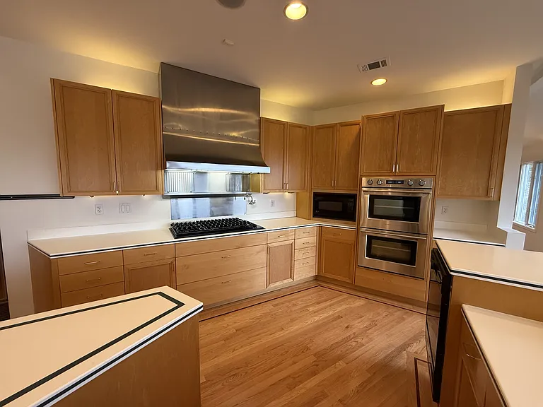 Chef's dream gourmet kitchen features two islands, freezer, refrigerator, two dishwashers, a pot-filler faucet and stainless-steel appliances.