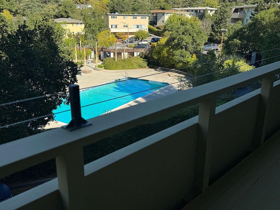 Pool and hillside view from deck