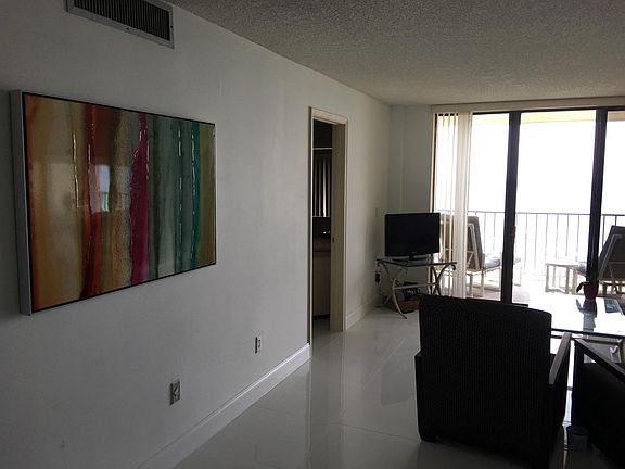 artwork from living room, views of ocean from kitchen area