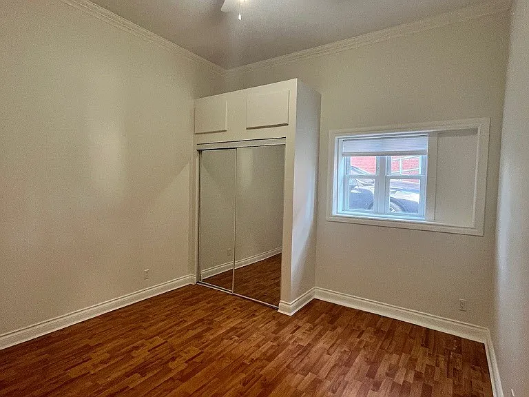 Comfortable bedroom with mirrored closets and additional storage