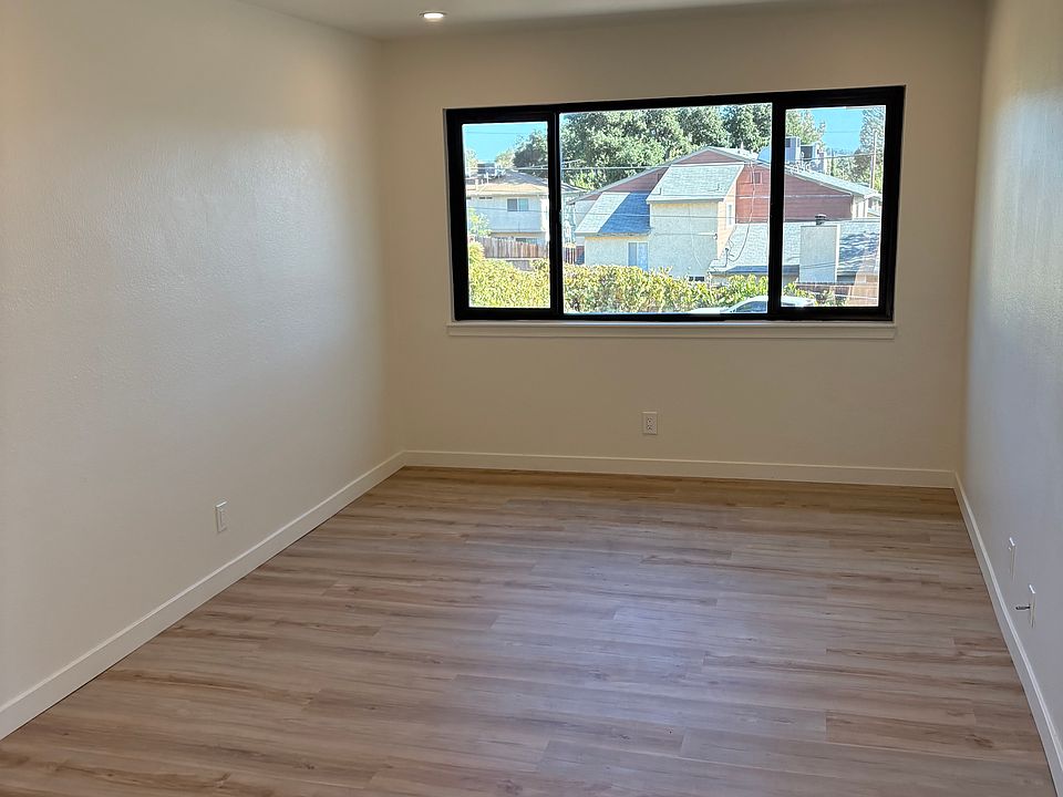 Living room, large window for lots of natural light and recessed led lighting