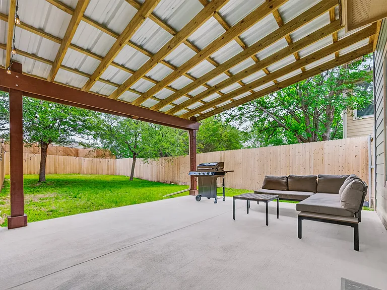 Large, covered outdoor patio; Grill, lighting, and patio furniture included