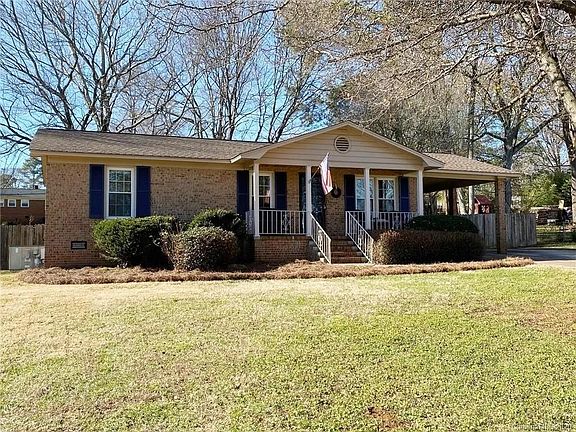 Large partially shaded front yard with sitting porch.