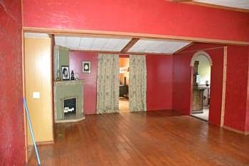 Upon entering you are in the main living space.  It has Pine flooring and is open to the dining area and the kitchen.  The room has a vaulted ceiling and warm inviting color.