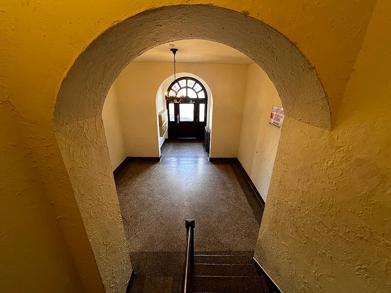 The lobby is very welcoming and well-lit. There is a secondary side entrance, not pictured, that conveniently lets out to the residential side street - where you will find ample parking.