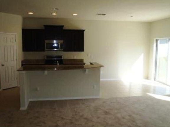 Kitchen nook off the kitchen features sliding glass door.