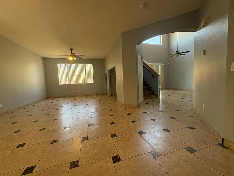 Through the Foyer into the formal Dining and living areas on the left and a Den on the right. Living area with a niche for television and room for AV equipment.