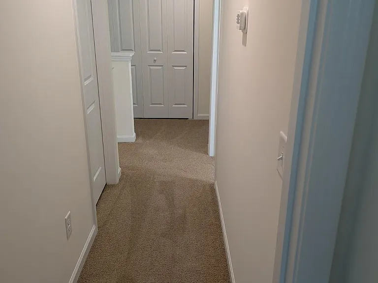 Upstairs hallway provides easy access to all four bedrooms and the laundry room, creating an open and spacious feel throughout the second level.